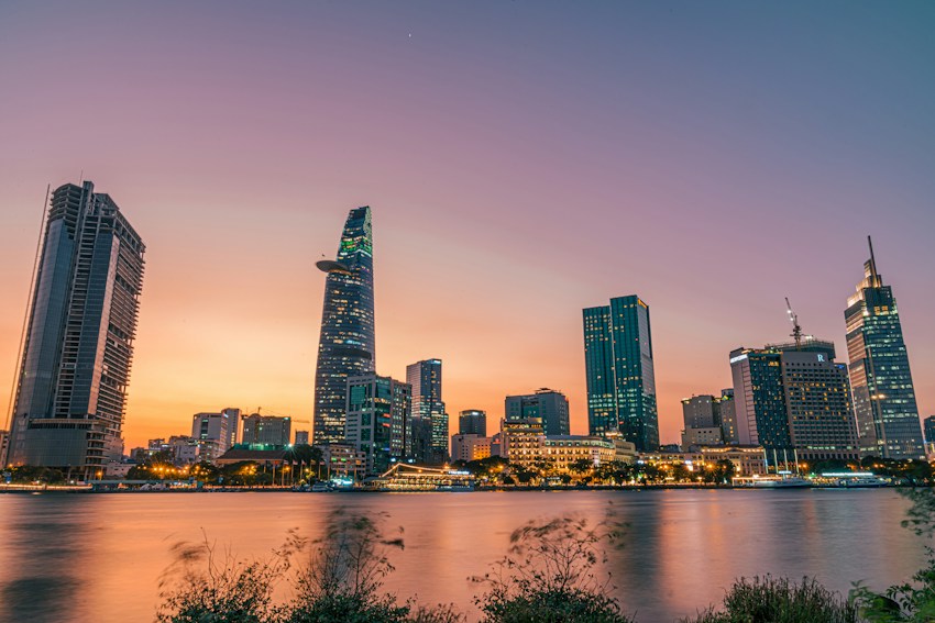 Ho Chi Minh City's skyline reflected in the Saigon River at sunset